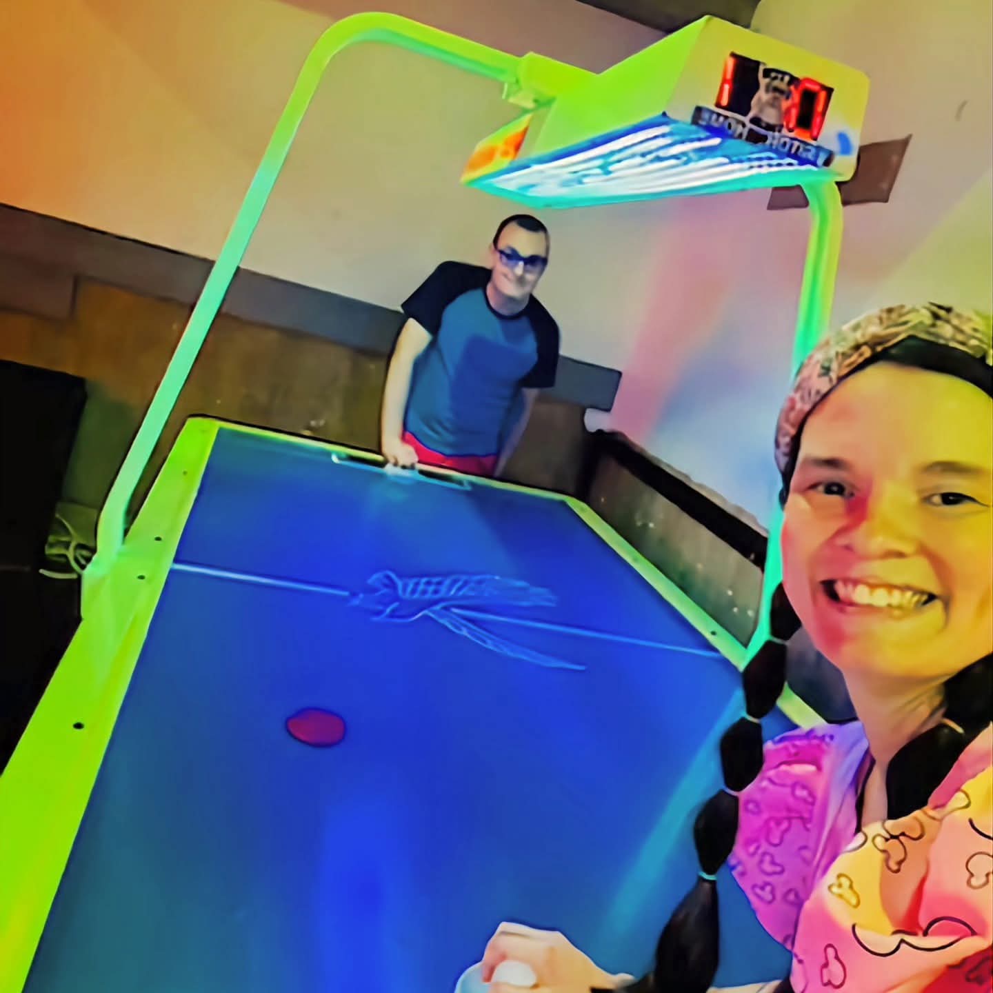 2025-09-16 1719 hours - Haley Kilburn and Brady play Air Hockey at Dublin's Pass Downtown