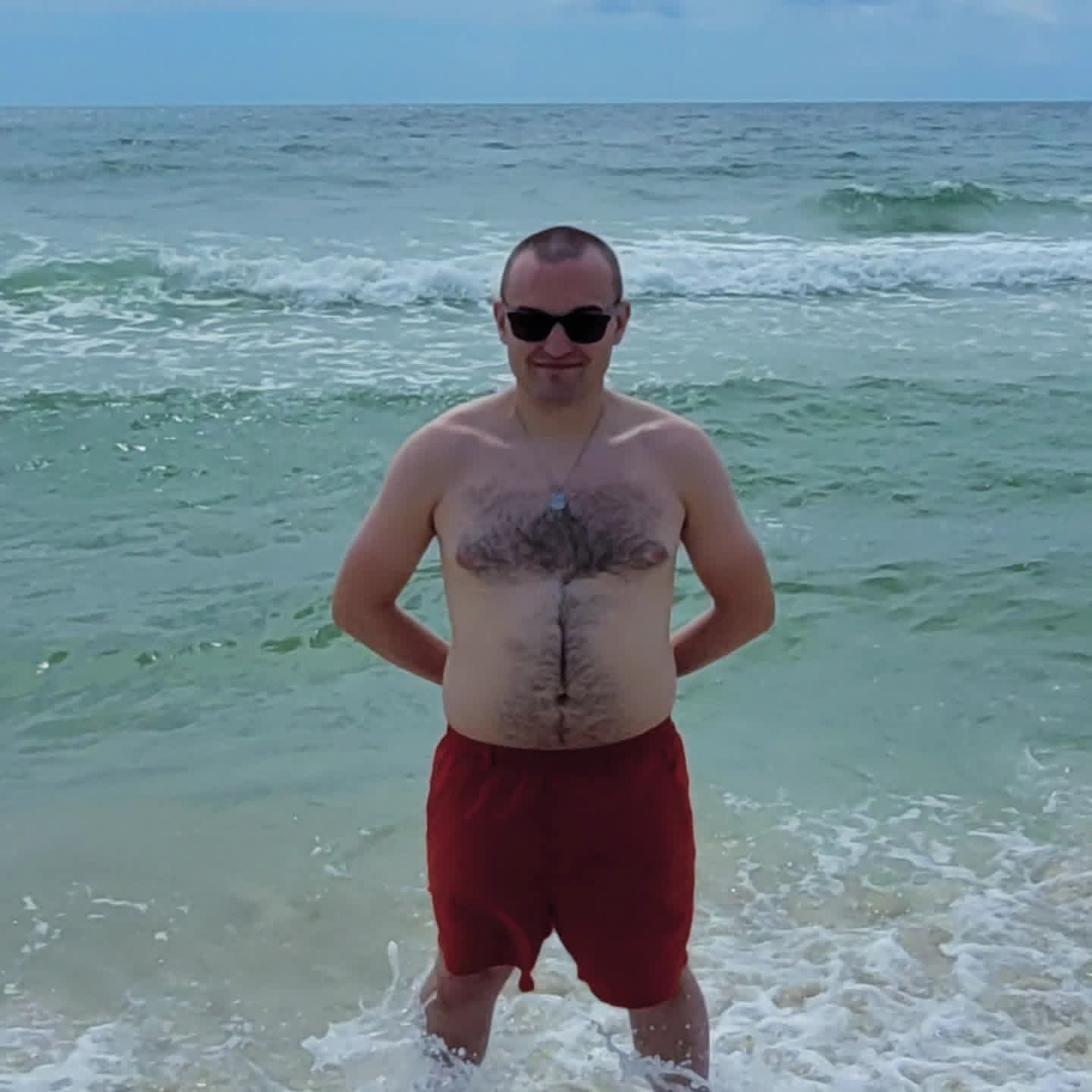 2025-09-22 1157 hours - Shirtless Brady on the Beach with Both Hands Behind his Back in Orange Beach