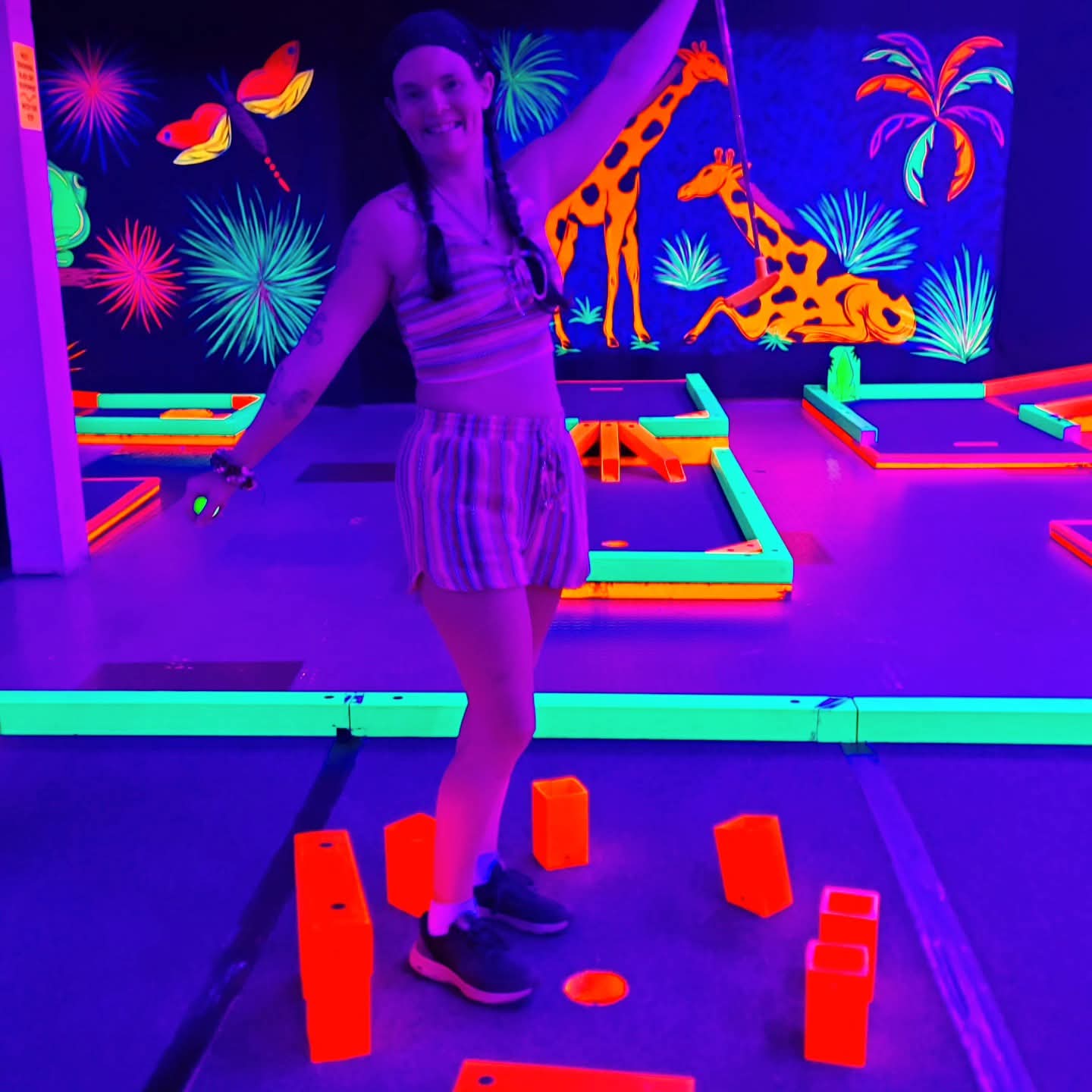 2025-09-30 1654 hours - Haley stands within 'Stonehenge' Scructure at Glow Golf