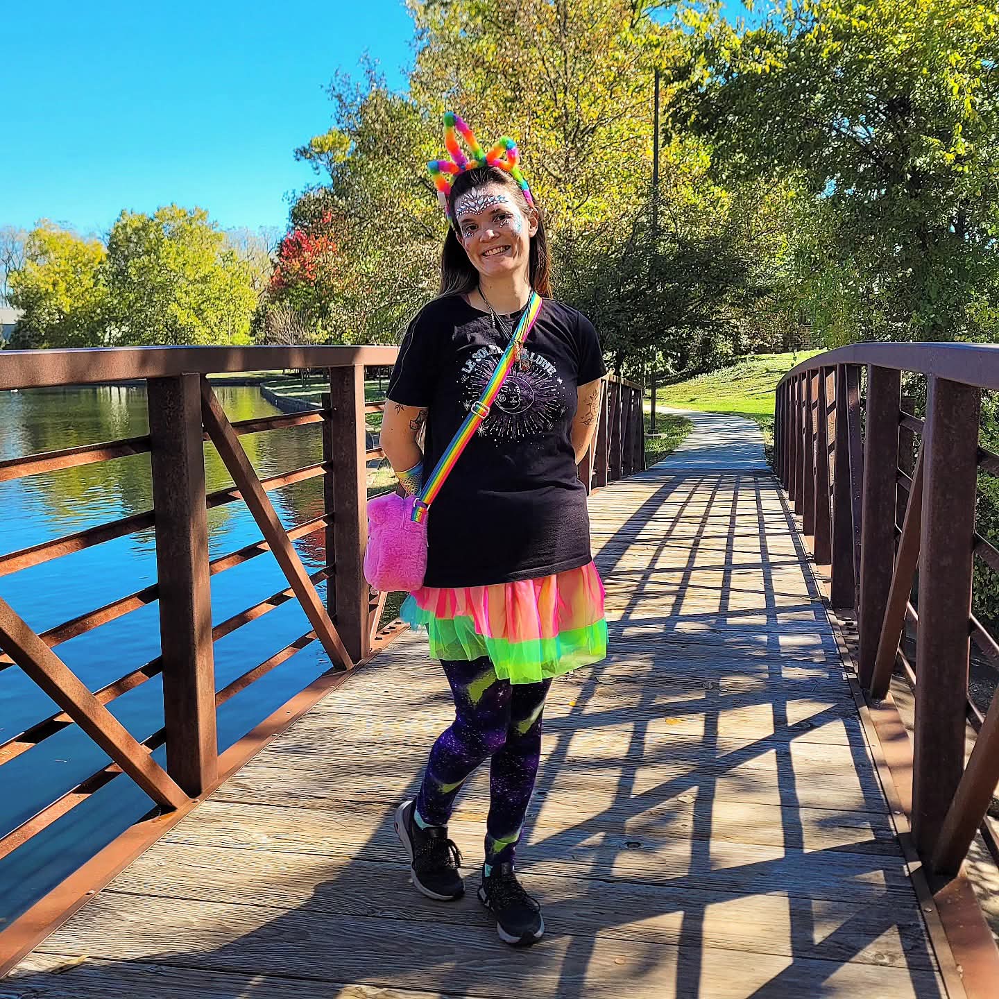 2025-10-31 1225 hours - Rainbow Unicorn Haley Kilburn, Hands Behind her Back, at Schaible Lake Park on Halloween MMXXV
