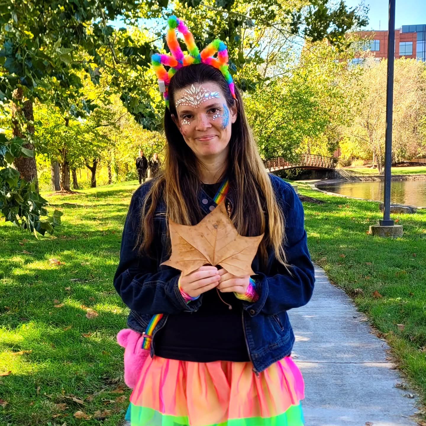 2025-10-31 1333 hours - Rainbow Unicorn Haley Holds a Brown Leaf for Fall Vibes at Schaible Lake Park on Halloween MMXXV