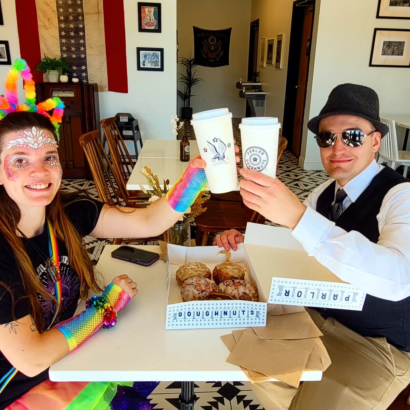 2025-10-31 1433 hours - Autism Buddies Rainbow Unicorn Haley & Cool Cat Brady enjoy Coffee & Doughnuts at Parlor Doughnuts Springfield on Halloween MMXXV